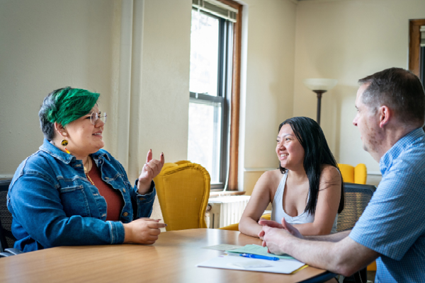 Holmes (left) talks with Yang (middle) and Pippert in the Augsburg Family Scholars lounge on campus. (Photo by Courtney Perry)